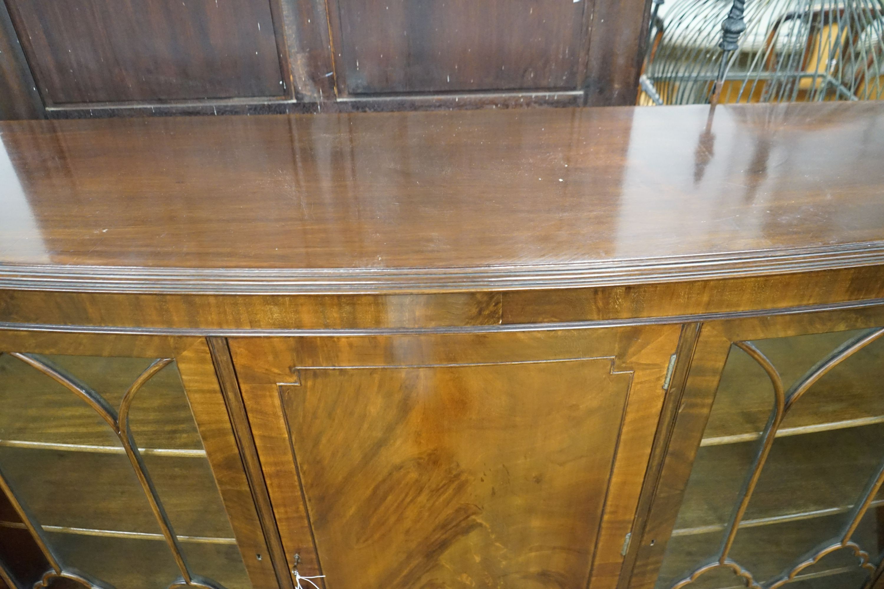 A 1920's mahogany bow front bookcase, width 152cm, depth 39cm, height 116cm